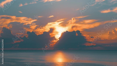 Sun rising above the sea at dawn. Colorful sunrise sky. 4K time-lapse.