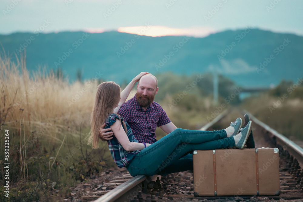Fototapeta premium Young happy couple on the tram railways
