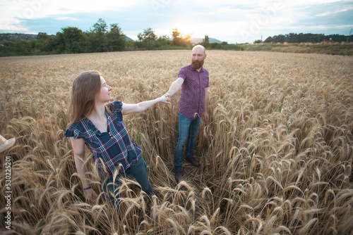 Loving couple in a wheat field.