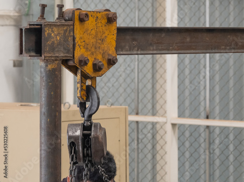 Fotografija The brown steel hoist is suspended on a movable yellow steel box rail