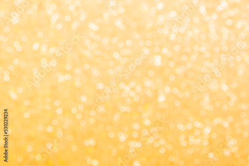 Gold light shiny bokeh abstract blur background with bright round defocus golden pattern