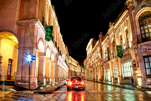 city at night in with golden lights with dark sky in zacatecas downtown  photo