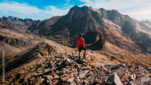 Photograph of a boy admiring the immensity of the mountains in the Panticosa Valley, a day of trekking next to the Vignemale peak, in the Pyrenees, Spain.
