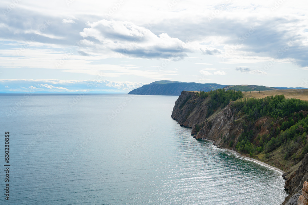Beautiful summer landscape of Baikal Lake on sunny day. View of the rocky cape