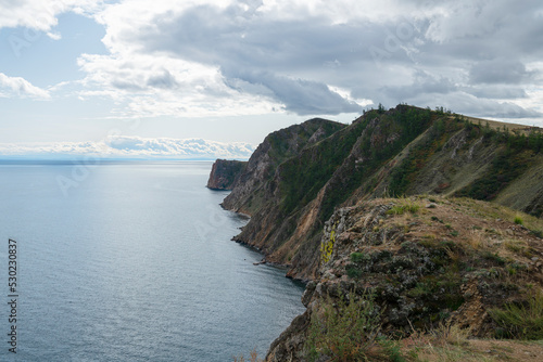 Beautiful summer landscape of Baikal Lake on sunny day. View of the rocky cape