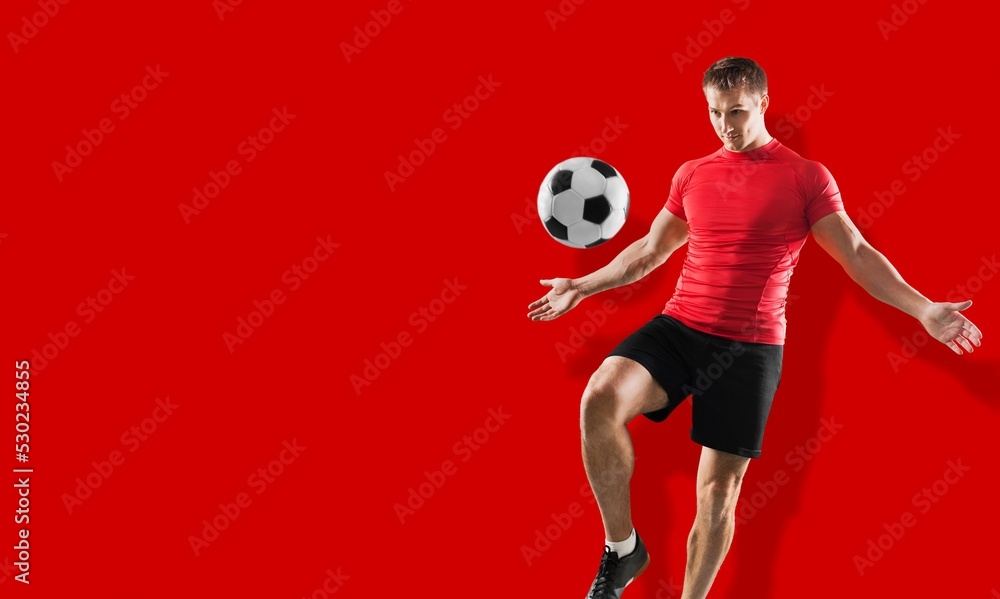 Overjoyed young man juggling soccer ball. Sport concept