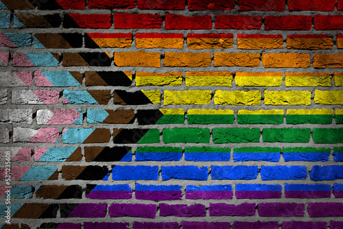 Fototapete Progress LGBTQ rainbow on a brick wall