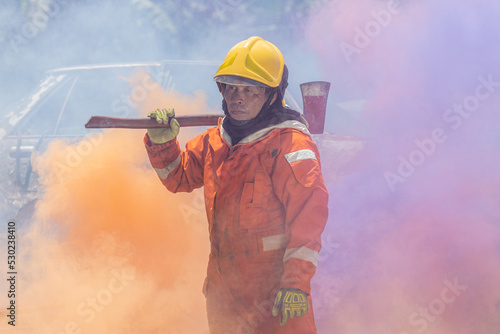 Firefighters wearing helmets with fire safety equipment Use Twirl aerosol fire extinguishers to fight oil flames.Preventing fire accidents is an industrial safety concept. 