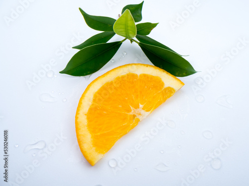 Fototapeta Naklejka Na Ścianę i Meble -  1 piece orange cut  with leaves, white background