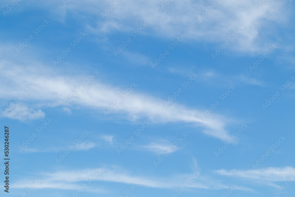 White fluffy clouds in the blue sky. Blue sky background and white clouds soft focus, pastel sky