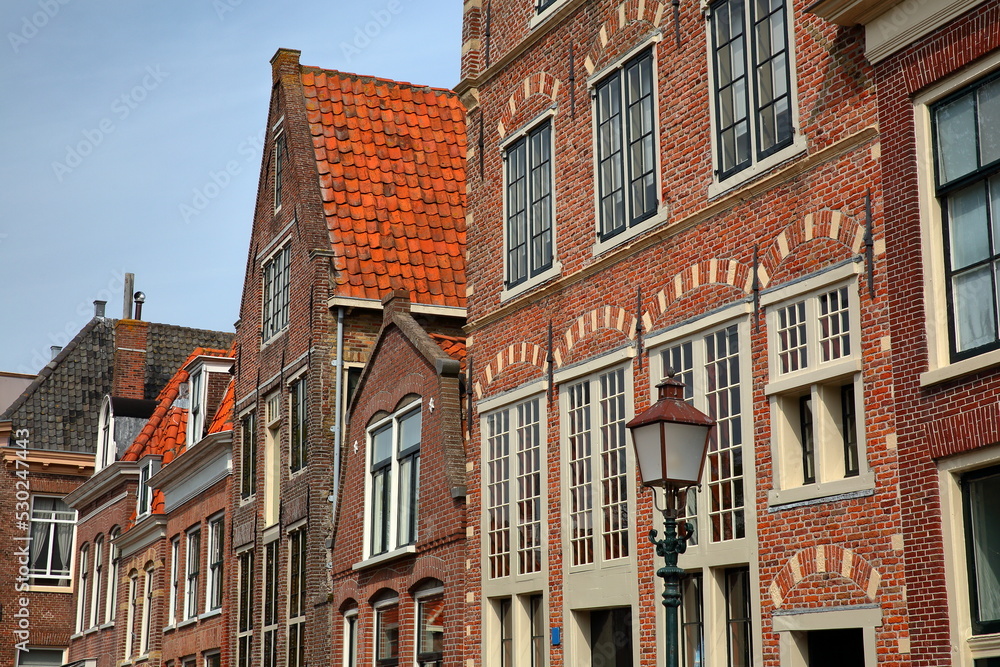 The colorful facades of historic houses located along Korenmarkt street near the harbor (Binnenhaven) of Hoorn, West Friesland, Netherlands