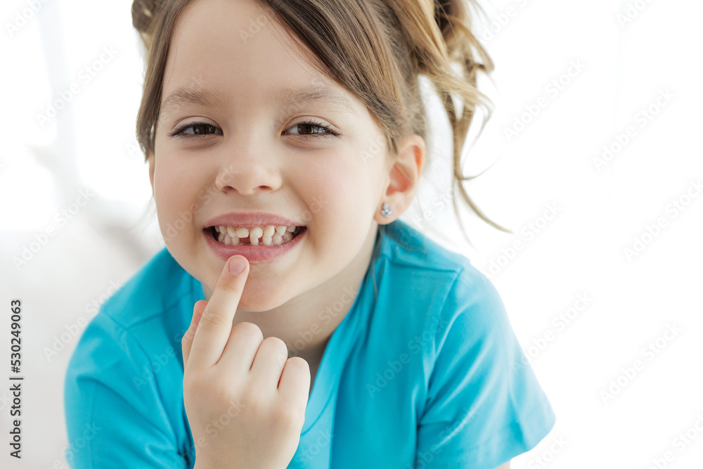 The child has lost a tooth. Little girl without a tooth. The first tooth fell out. High quality photo The child has lost a tooth. Little girl without a tooth. The first tooth fell out. High quality photo