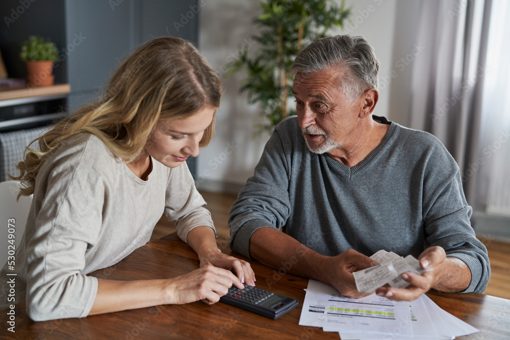 Senior man with adult daughter looking for solution in financial problem. Documents prepare special for shoot. Senior man with adult daughter looking for solution in financial problem. Documents prepare special for shoot.