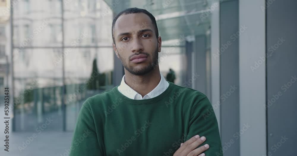 Portrait of Serious Multiracial Manager Standing Looking Camera Outside Near Business Center. Handsome Businessman Feeling Confident. Slow Motion Portrait of Serious Multiracial Manager Standing Looking Camera Outside Near Business Center. Handsome Businessman Feeling Confident. Slow Motion
