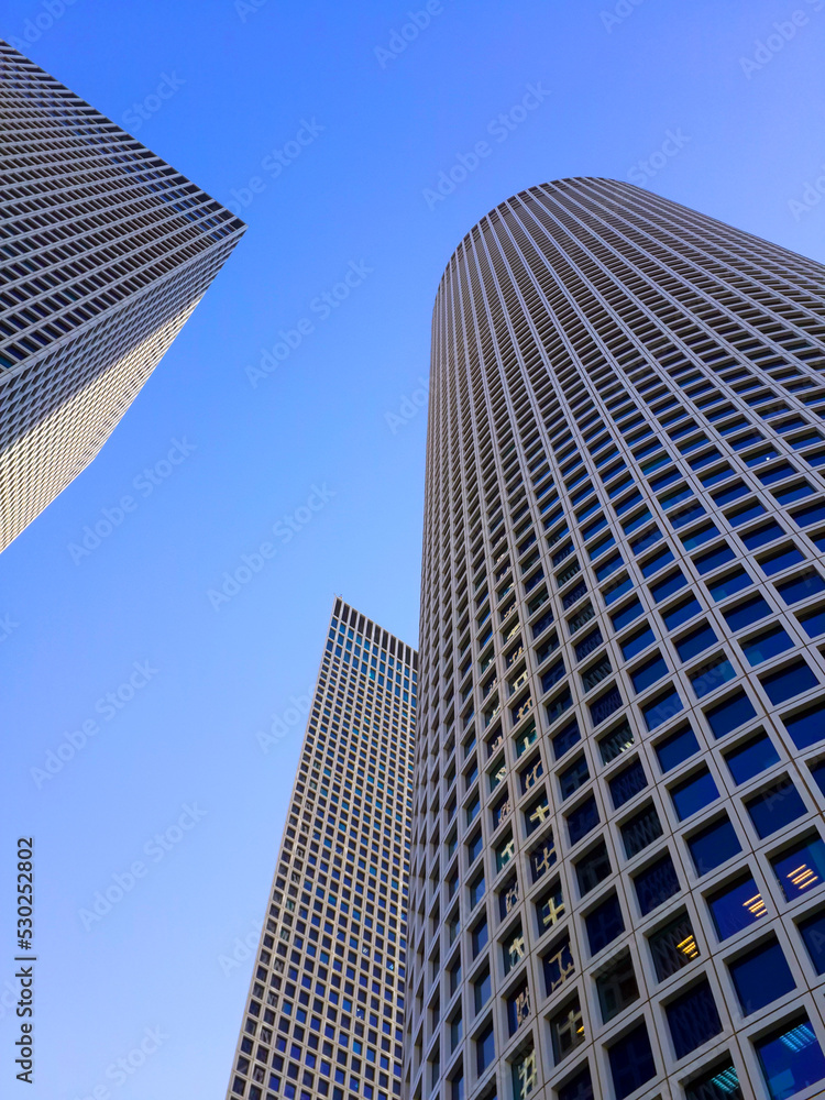 Circular and quadrangular building of business center. Modern business building against blue sky in Tel Aviv