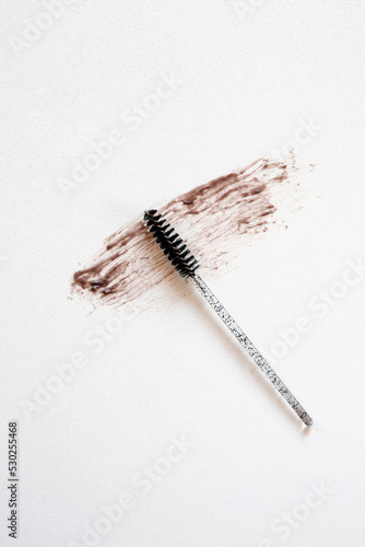 Brush for combing eyebrow hairs. Background for text. View from above