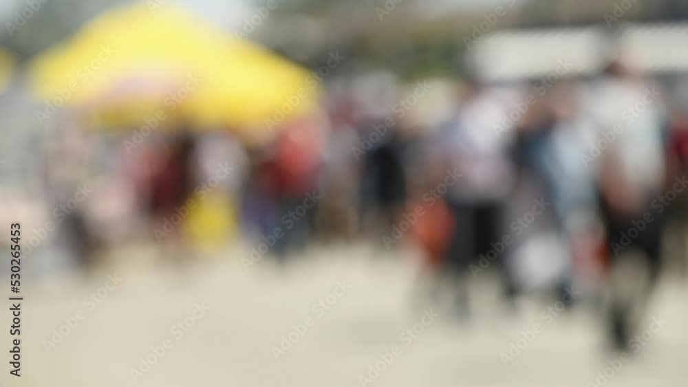 Crowd of anonymous people on the street in summer, tourist pedestrians walking in the city, selective focus Crowd of anonymous people on the street in summer, tourist pedestrians walking in the city, selective focus