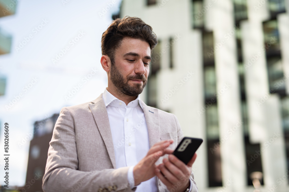 Businessman using his cellphone on a city road Businessman using his cellphone on a city road