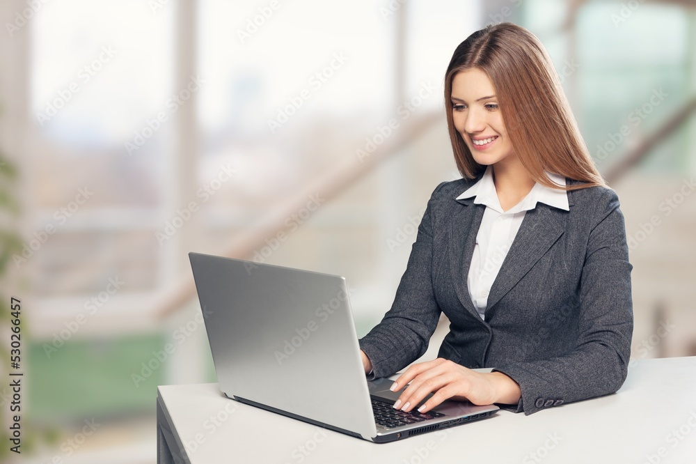 Optimistic worker or student while browsing data on laptop Optimistic worker or student while browsing data on laptop
