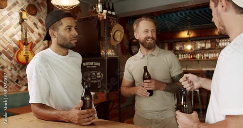 Wallpaper Mural Group of friends drinking beer, Male colleagues in good mood drinking draft beer and relaxing. Concept of friendship and leisure. A multiracial Friends enjoying the weekend night together in a bar Torontodigital.ca