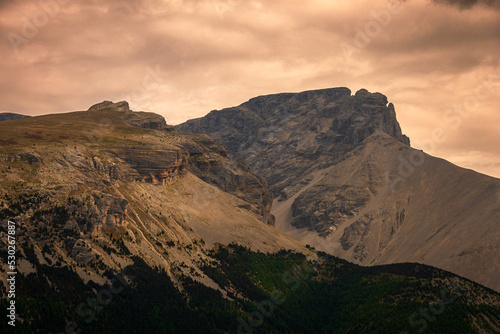 small peaks in the The French alps with stormy weather clouds , changing climate .