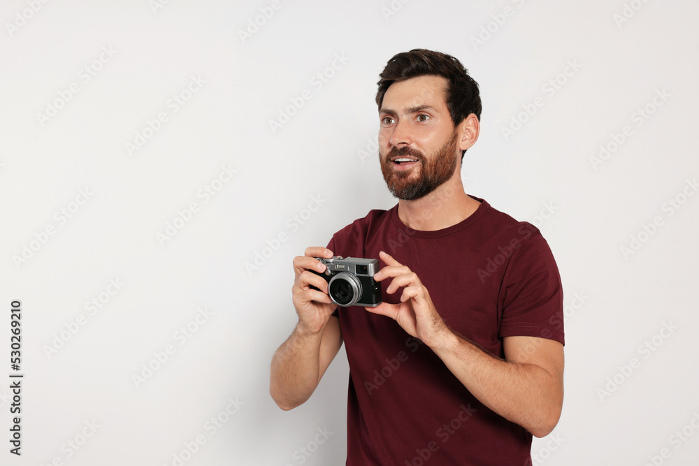 Man with camera on white background, space for text. Interesting hobby Man with camera on white background, space for text. Interesting hobby