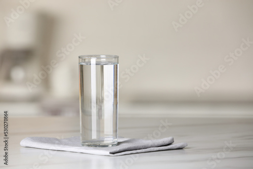 Obraz na plátne Glass of pure water on white table indoors, space for text