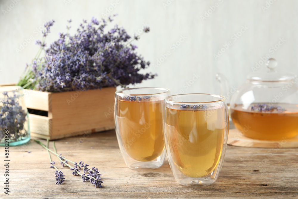 Fototapeta premium Fresh delicious tea with lavender in glass on wooden table