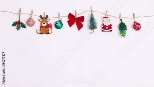 Wallpaper Mural Various Christmas decorations and ornaments hanged on rope on white background with copy space. Flat lay New year holidays garland Torontodigital.ca
