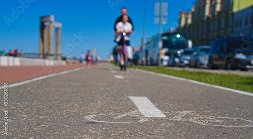 Wallpaper Mural A bike path with passing scooters. Rest on a scooter on a bike path. People on a scooter. Torontodigital.ca