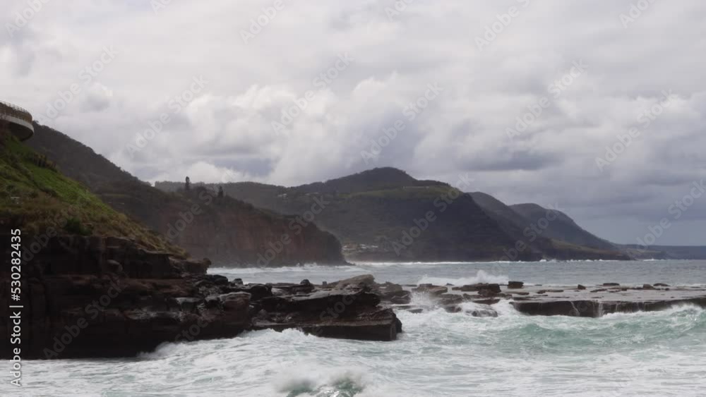 Rough waves rolling into the shore on the South Coast of Australia Rough waves rolling into the shore on the South Coast of Australia