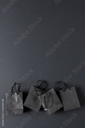 Composition of gray paper shopping bags on gray background