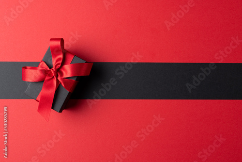 Composition of present with pink ribbon on gray and pink background