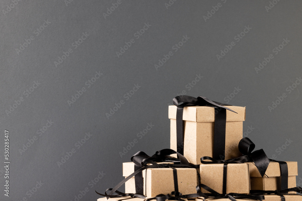 Composition of presents with black ribbons on gray background Composition of presents with black ribbons on gray background