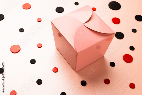 Composition of present and colourful spots on white background