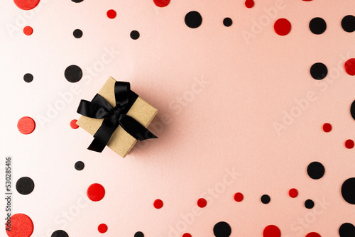 Composition of present and colourful spots on white background