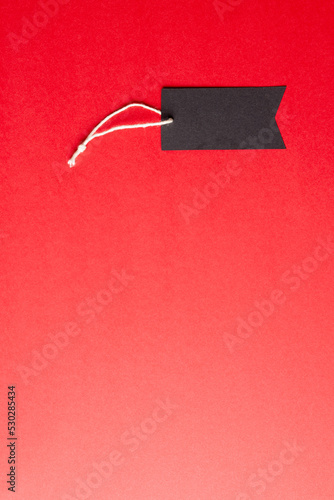 Composition of gift tag with copy space on red background