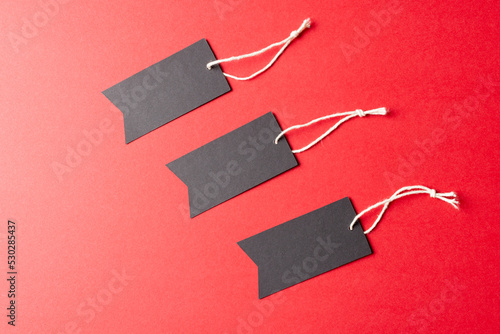 Composition of gift tags with copy space on red background