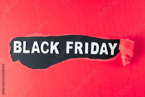 Composition of pink paper and black friday text on black background