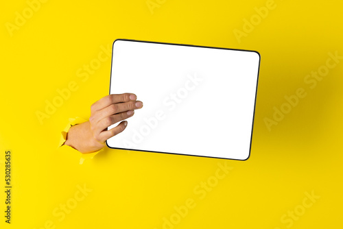 Composition of hand holding board with copy space on yellow background