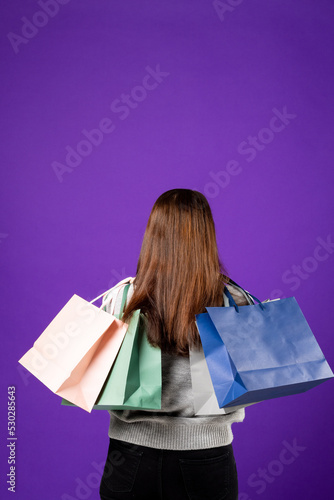 Composition of woman holding shopping bags on blue background