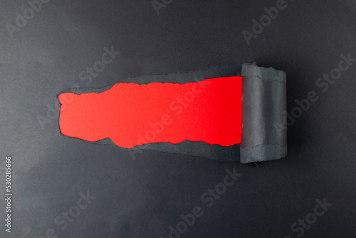 Composition of black paper and copy space on red background