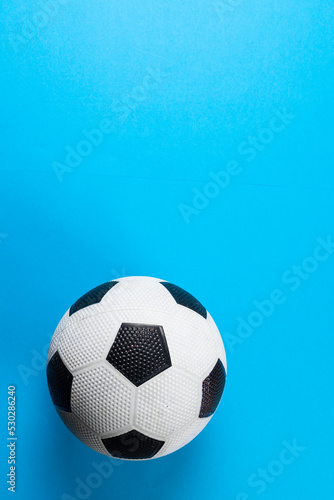 Composition of football on blue background with copy space