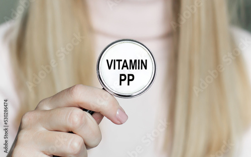 PP vitamin text on a stethoscope in the hands of a doctor, medical concept photo