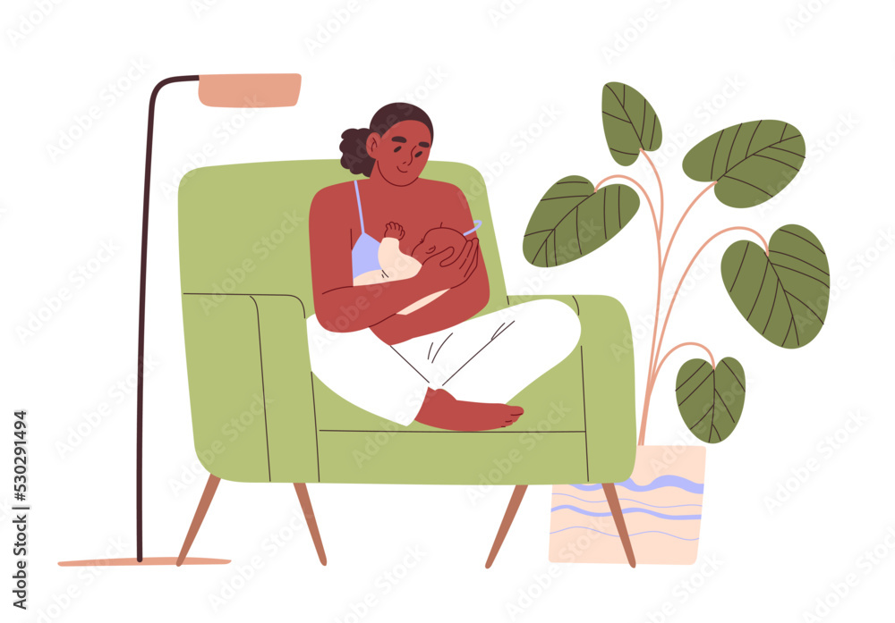 Woman breastfeeding her baby while sitting in armchair at home