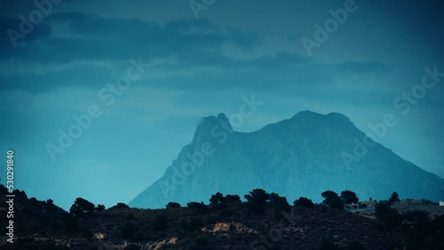 Timelapse of night is falling over Peak Puig Campana. Alicante province, municipality of Finestrat. View from Xarco coast. photo