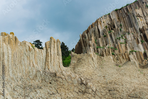 high coastal cliff made of columnar granite, landscape on the island of Kunashir