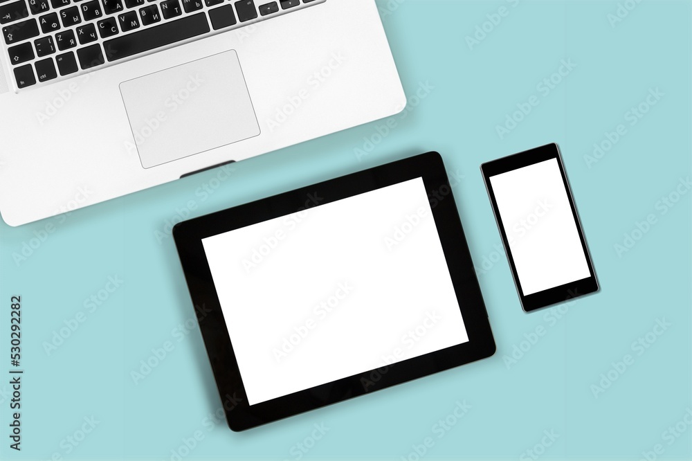 Tablet and smartphone with blank screen on desk. Business Tablet and smartphone with blank screen on desk. Business