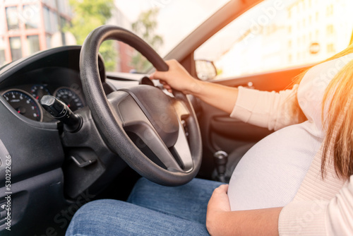 Pregnant woman driver. Beautiful smiling pregnancy woman driving car. Safety pregnant young mother drive concept.