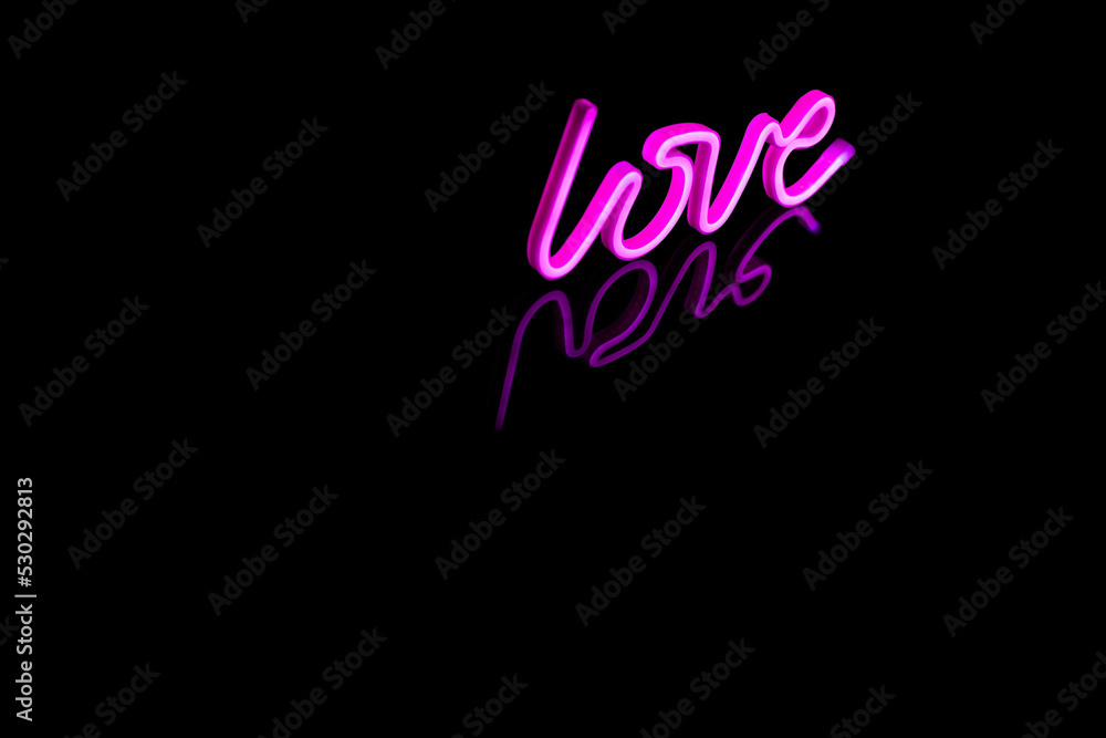 Image of vibrant neon love text formed with pink glow sticks over black background and copy space Image of vibrant neon love text formed with pink glow sticks over black background and copy space